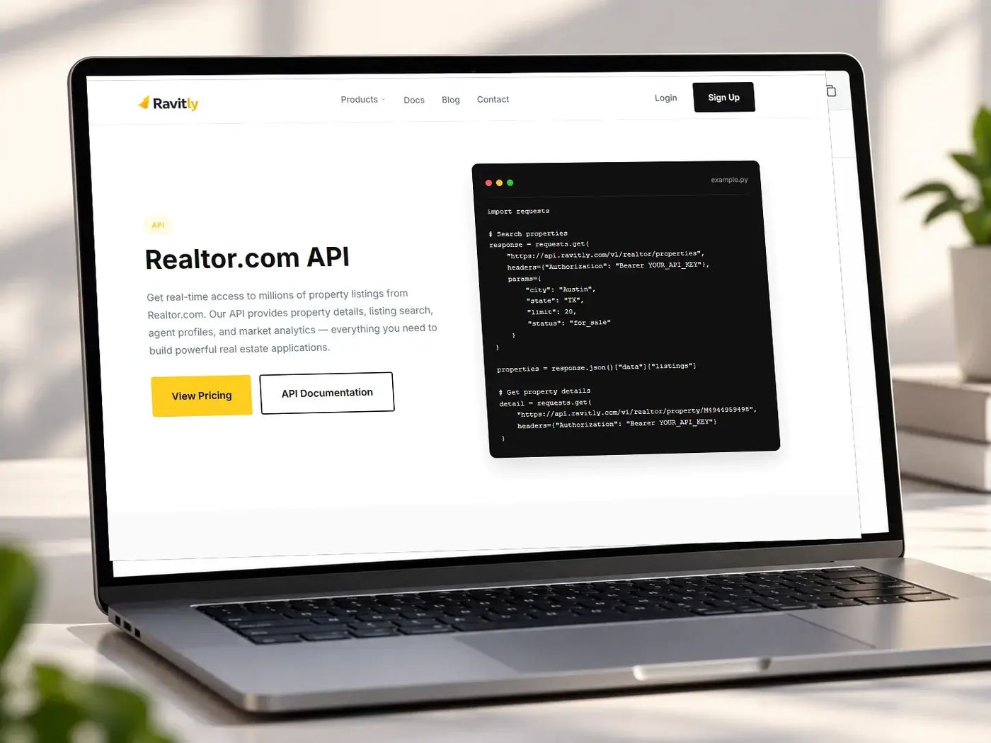 Laptop showing the Ravitly Realtor.com API page and a short Python example